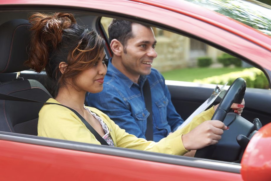 Learner driver at the wheel with a driving instructor